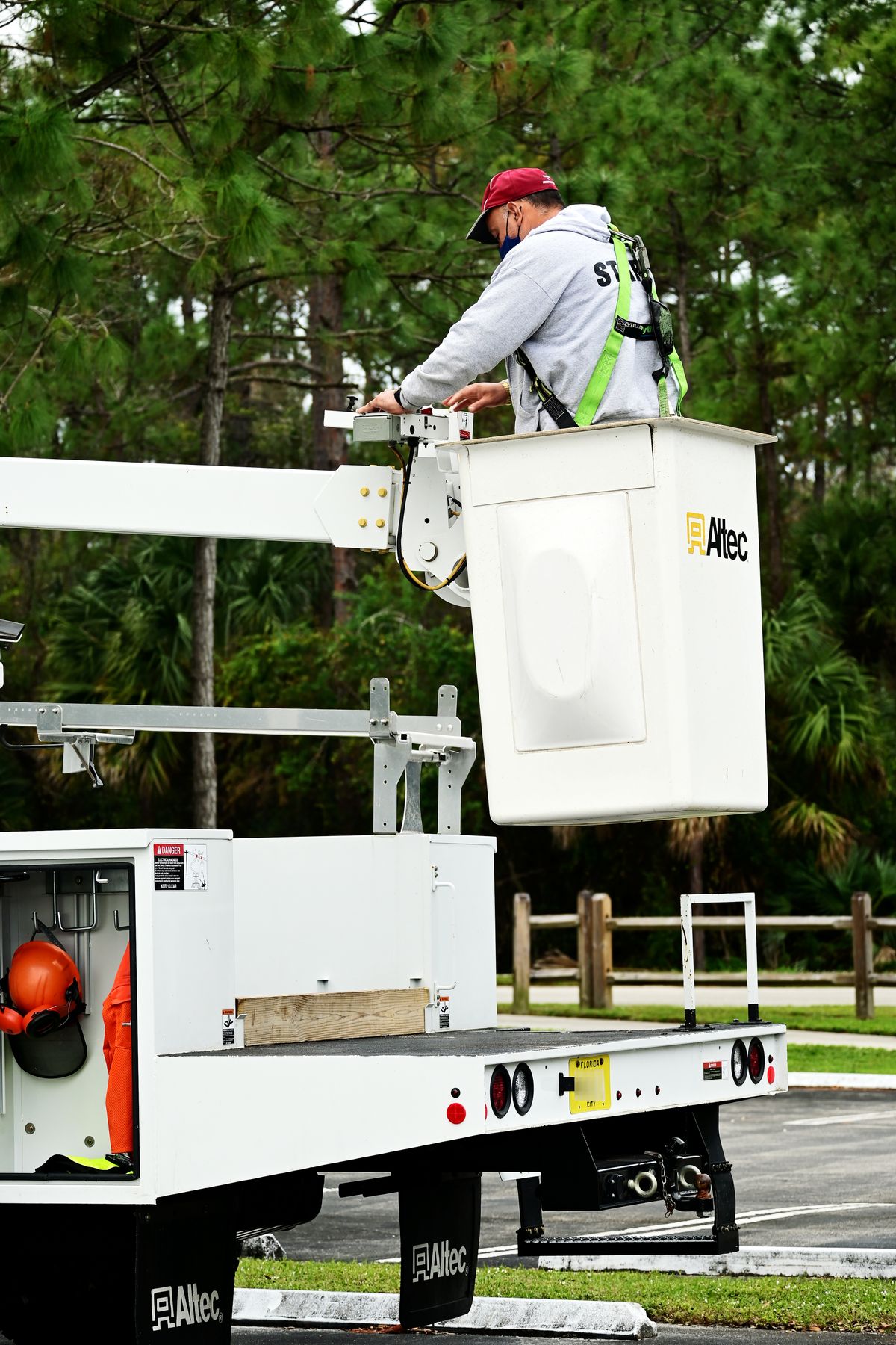 Tree service worker operating a bucket truck